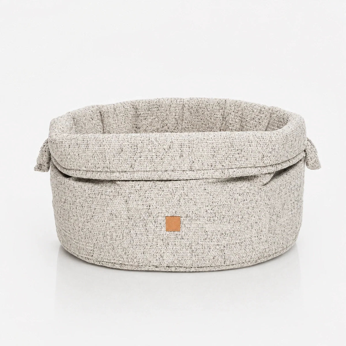Panier rond en chenille pour chien avec bord replié et anses latérales