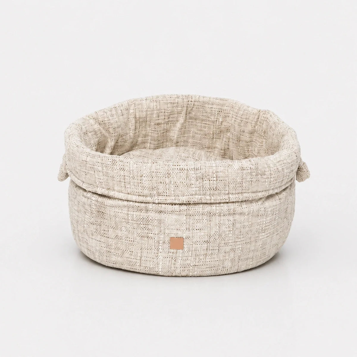 Panier rond en chenille pour chien avec bord replié et anses latérales